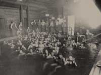 A group of boys swims at the old bathhouse at Givens Hot Springs. Below is a picture of the Givens? hotel, circa 1903.