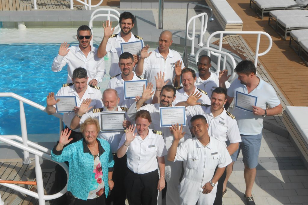 Graduates of a CPO course taught by Connie Sue Centrella (front, far left) gather on the deck of the Azamara Quest in the Greek islands (photo courtesy C.S. Centrella)