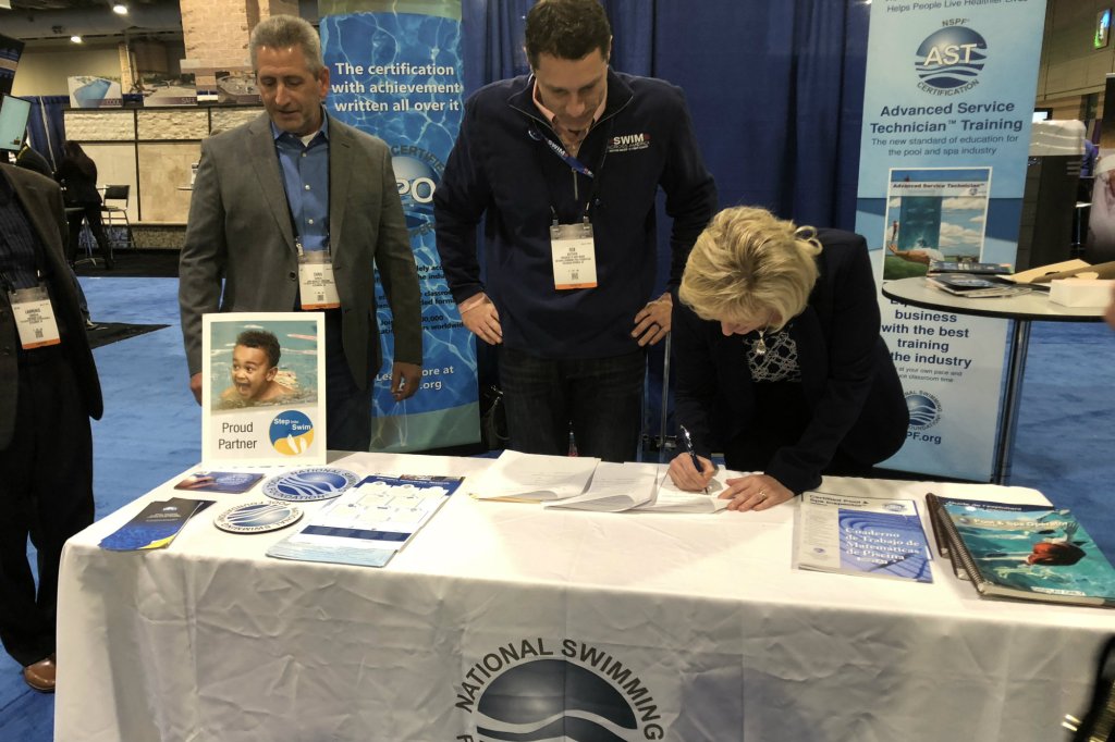 Butcher (center) and Williams (right) sign the unification agreement Jan. 29 in Atlantic City, N.J., at The Pool and Spa Show: Powered by the Northeast Spa and Pool Association.