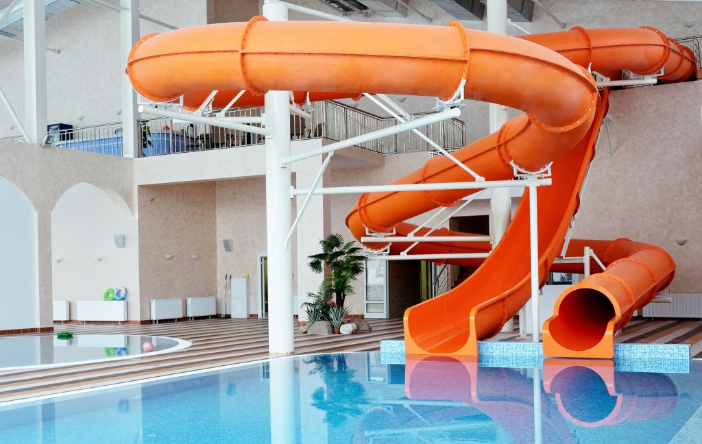 Orange waterslide, indoor pool
