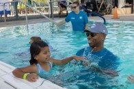 U.S. Olympic Gold Medalist, Cullen Jones, helps students learn water safety skills at the Valley of The Sun YMCA/Leslie's World's Largest Swimming Lesson event in Phoenix, AZ. Jones shared his personal water safety/learn to swim story to help raise awareness about the importance of learning to swim and using layers of protection including adult supervision and preventing access to water with fencing and pool covers.