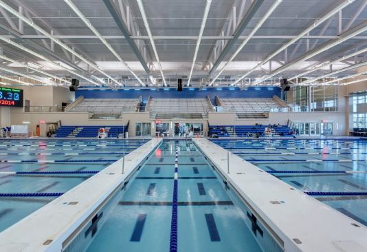 The competition space features an eight-lane, 50- meter pool with movable bulkheads for maximum versatility. While the intention is to install springboards on one end of the pool in the future, that area was made deep enough to accommodate a diving tower, just in case. The competition space also has dedicated locker rooms, a separate entry, and a guard/official office, as well as both fixed and “tip and roll” bleachers for spectators.