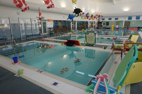 Beginners are taught in the 30-by-30-foot, 4-foot deep area. Mosaics on the pool floor and foam sculptures on the ceiling help stimulate children to learn. The two pools behind it are meant for child-and-parent classes.