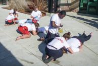 Rescuers in Action: When checking for breathing and pulse in the cephalic position, remember to continue to look down the victim's chest.