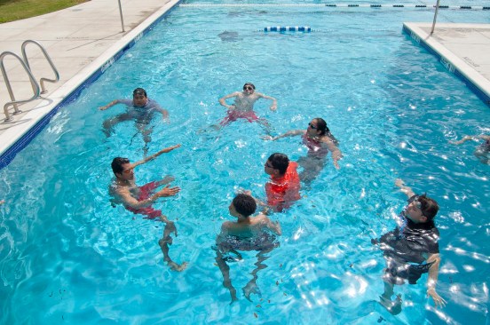 An instructor goes over the fundamentals of swimming with students at Lyndon B. Johnson Early College High School in Austin. Students generally come into the course with very limited water skills. 