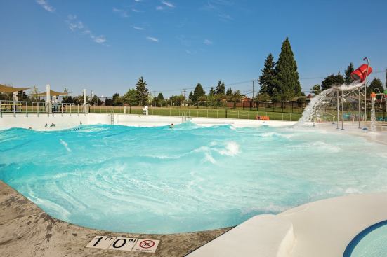 The wave pool at Kandle Park & Pool in Tacoma, Wash.,— the first in the county and one of a few in the state of Washington — features 120 linear feet of zero-depth beach area for accessibility. The machines produce up to 3-foot waves in multiple configurations, yet imitating the ocean isn’t the sole purpose of this attraction. Instead, features such as a dumping bucket, the “fumbling five,” and water cannons were included to engage those not looking to hang 10. The pool also hosts swim lessons and off-hours lap swimming, which take place in four 25-meter lanes placed in the deep end.