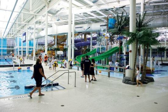 After a long and anticipated wait, the Macdonald Island Park celebrated its grand opening in the fall of 2010. The completed aquatic center provides interactive play, fitness, recreation, educational, wellness and therapy and competition opportunities, offering six different water

temperatures. From coolest (1) to warmest (6) the various areas include: A 54-meter competition pool with one 3-meter and two 1-meter spring boards (1); a four-lane, multi-purpose warm-up/teaching pool (2); an activity sprayground featuring a play structure with more than 40 spray features (3), a zero-depth activity pool with a beach entry, lazy river and 2 water slides (4), a family whirlpool (5) and an adult whirlpool (6). The mix of features provides inter-generational appeal while accommodating a spectrum of activities including family, learn-to-swim, wellness and therapy, high-end competition and water sports.
