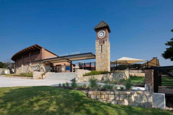 Opened in 2010, the West Irving Aquatic Center was designed to complement another facility on the other side of town. In designing the aquatic center a major challenge was the site layout. The selected site is bisected by a deep creek, effectively limiting where a new facility could go. As

a result designers created a unique footprint that works with the site and is anchored by a large clocktower, visible from outside and inside the facility.