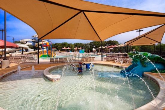 Shade structures like the one over the tot pool, and terraced deck space create a sense of visual drama and make the $4.1 million West Irving Aquatic Center unique.