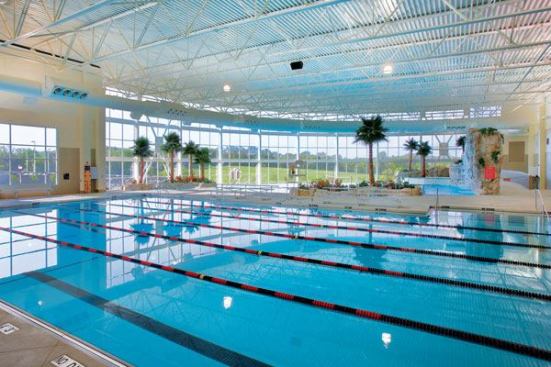For lap swimming, the facility includes a 6-lane-by-25-yard lap pool. There’s also a 12-person whirlpool spa, men’s and women’s locker facilities, on-deck steam and sauna rooms, administrative and lifeguard offices, an aquatic multi-purpose room, a first-aid office, and storage space. The tropical-theme facility was planned with a number of sustainable design principles, including designing the site for minimal impact, specifying materials with low levels of VOC content where possible, and utilizing efficient building mechanical systems.