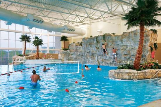 The most noteworthy feature of the leisure pool is a one-of-a-kind realistic bouldering wall with a variety of climbing holds for all levels of expertise.Southeast Missouri State’s 40-foot-wide-by-14-foot-high wall allows users to climb and fall into the 7-foot-deep leisure pool.

Taking four weeks to complete, it was formed upon dozens of concrete fabricated panels mounted on a steel cage. All rock features were cast in place, using forms based on real rocks, and the result is a wall that looks and feels like real rock, providing as close to a real-life climbing experience as possible. The leisure pool also includes water basketball and volleyball areas, a rope swing, a “bubble-bench” overlooking windows framing the pool’s vanishing edge, and a zip line.